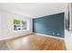 Bright, open living room with hardwood floors and a striking blue accent wall at 325 Mulberry Cir, Broomfield, CO 80020
