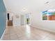 Large open living room with sliding glass doors, tile flooring, and stairway at 325 Mulberry Cir, Broomfield, CO 80020