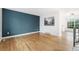 Bright, open living room with hardwood floors and a striking blue accent wall at 325 Mulberry Cir, Broomfield, CO 80020