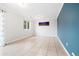 Empty living room featuring tile flooring, modern lighting, and neutral walls at 325 Mulberry Cir, Broomfield, CO 80020