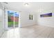 Bright living room with neutral walls, tile floors, and a sliding glass door to the backyard at 325 Mulberry Cir, Broomfield, CO 80020