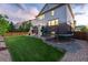 Spacious backyard featuring a slide, trampoline, swings, and expansive green lawn at 6236 S Millbrook Way, Aurora, CO 80016