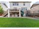 Well-maintained backyard featuring a slide, trampoline, swings, and manicured green lawn at 6236 S Millbrook Way, Aurora, CO 80016