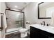 Modern bathroom with glass shower door, dark vanity, and updated fixtures at 6236 S Millbrook Way, Aurora, CO 80016