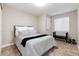 This inviting bedroom features neutral colors, a comfy bed, and natural light, creating a relaxing retreat at 6236 S Millbrook Way, Aurora, CO 80016