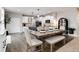 Inviting dining room featuring a rustic table set and adjacent kitchen with white cabinetry at 6236 S Millbrook Way, Aurora, CO 80016