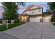 Beautiful two-story home with a well-maintained lawn, stone accents, three car garage and covered porch at 6236 S Millbrook Way, Aurora, CO 80016