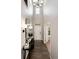 Inviting foyer featuring hardwood floors, white door, a console table, mirror and elegant decor at 6236 S Millbrook Way, Aurora, CO 80016