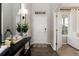 Inviting foyer with hardwood floors, white door, a console table, mirror and elegant decor at 6236 S Millbrook Way, Aurora, CO 80016