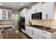 Well-appointed kitchen featuring granite countertops, white cabinets, and stainless steel appliances at 6236 S Millbrook Way, Aurora, CO 80016