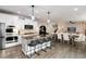 Open concept kitchen featuring island seating and seamless transition to the dining and living areas at 6236 S Millbrook Way, Aurora, CO 80016
