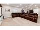 This luxurious living room features a comfortable leather sectional and well-lit space at 6236 S Millbrook Way, Aurora, CO 80016