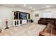 Spacious living room featuring custom built-ins, plush leather seating, and carpet flooring at 6236 S Millbrook Way, Aurora, CO 80016