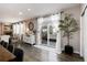 Cozy living area with a dining area, fireplace, sliding glass doors, and an adjacent kitchen at 6236 S Millbrook Way, Aurora, CO 80016