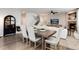 Open-concept living space with a rustic dining table flowing into a cozy living room at 6236 S Millbrook Way, Aurora, CO 80016