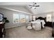 Spacious main bedroom suite with vaulted ceilings, large windows, and comfortable seating area at 6236 S Millbrook Way, Aurora, CO 80016