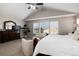 Spacious main bedroom suite with vaulted ceilings, large windows, and comfortable seating area at 6236 S Millbrook Way, Aurora, CO 80016