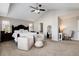 Spacious main bedroom suite with vaulted ceilings, large windows, and comfortable seating area at 6236 S Millbrook Way, Aurora, CO 80016