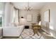 Bright and stylish home office with modern lighting, desk, white sofa, and neutral decor at 6236 S Millbrook Way, Aurora, CO 80016