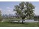Scenic view of the city skyline, pond, and green spaces in a serene park setting at 81 N Meade St, Denver, CO 80219