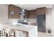 Modern kitchen with stainless steel appliances, island with seating, and stylish pendant lighting at 81 N Meade St, Denver, CO 80219