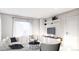 Inviting living room featuring a sofa, chairs, and open shelving with decorative items at 81 N Meade St, Denver, CO 80219