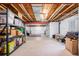 Unfinished basement with exposed ceiling, concrete floor, and storage shelving at 11499 Kenton St, Commerce City, CO 80640