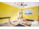 Bedroom with a ceiling fan, a large window, and ample natural light, offering a comfortable living space at 11499 Kenton St, Commerce City, CO 80640