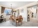 Elegant dining area featuring a classic table setting, a built-in display case, and access to living spaces at 11499 Kenton St, Commerce City, CO 80640
