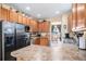 Bright kitchen featuring stainless steel appliances, wood cabinets, and views to the breakfast nook at 11499 Kenton St, Commerce City, CO 80640