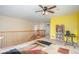 Bright landing featuring carpet, a wooden banister, and views of the home's layout and design elements at 11499 Kenton St, Commerce City, CO 80640
