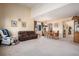 Open-concept living and dining area with a high ceiling, neutral carpet, and ample natural light at 11499 Kenton St, Commerce City, CO 80640