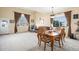 Bright living and dining area with large windows, comfortable seating, and a stylish dining table at 11499 Kenton St, Commerce City, CO 80640