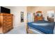 Cozy bedroom featuring a wooden dresser, soft carpeting, and lots of natural light at 11499 Kenton St, Commerce City, CO 80640