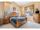 Elegant bedroom with a wooden bed frame, large windows, and neutral décor at 11499 Kenton St, Commerce City, CO 80640