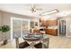 Kitchen with wood cabinets and eat-in area at 406 Titan Ct, Aurora, CO 80011