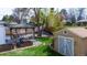 Well-maintained backyard with gazebo, storage shed, mature trees, and walkway at 6045 S Cook St, Centennial, CO 80121