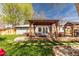 Beautiful backyard with an outdoor dining space under a pergola and a nice stone fire pit at 6045 S Cook St, Centennial, CO 80121