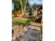 Landscaped backyard with a lush lawn, rock border, stone pavers, playhouse, and an adjacent deck at 6045 S Cook St, Centennial, CO 80121
