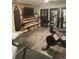 Home gym in basement with wood paneling and exercise equipment at 6045 S Cook St, Centennial, CO 80121