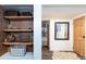 Finished basement with shelving and storage space, and a connecting door to another room at 6045 S Cook St, Centennial, CO 80121