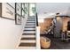 Finished basement with home gym, modern lighting, and easy access to the staircase at 6045 S Cook St, Centennial, CO 80121