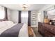 Comfortable bedroom features a large bed, dresser, and decorative artwork and wall sconces at 6045 S Cook St, Centennial, CO 80121