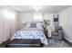 Comfortable bedroom with a queen bed, cushioned bench, and an accent chair near a large window at 6045 S Cook St, Centennial, CO 80121