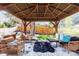 Cozy backyard gazebo with comfortable seating and stylish decor, perfect for outdoor relaxation and entertaining at 6045 S Cook St, Centennial, CO 80121