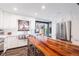 Bright kitchen with stainless steel appliances and large island featuring a unique wooden countertop at 6045 S Cook St, Centennial, CO 80121