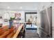 Bright kitchen boasts a large wooden island, stainless appliances, and decorative tree accent at 6045 S Cook St, Centennial, CO 80121