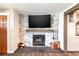 Comfortable living room with a fireplace, stone accent wall, and a flat-screen television at 6045 S Cook St, Centennial, CO 80121