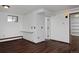 Basement recreation room with a built-in desk and wood floors at 1340 Deerpath Trl, Franktown, CO 80116