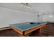 Basement recreation room with a pool table and wood floors at 1340 Deerpath Trl, Franktown, CO 80116